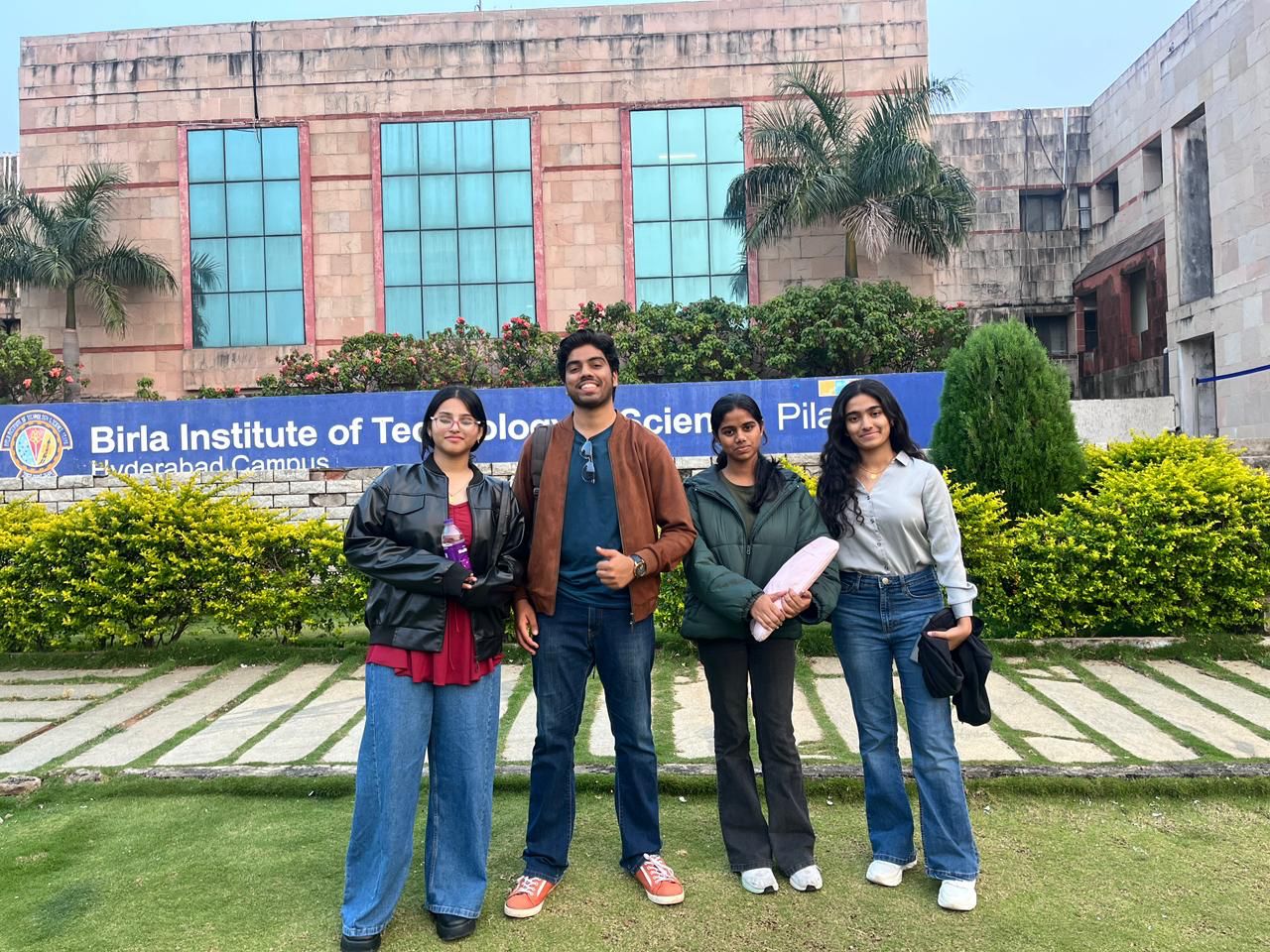 Victor with three fellow participants in front of the Birla Institute of Technology and Science, Pilani, Hyderabad Campus sign