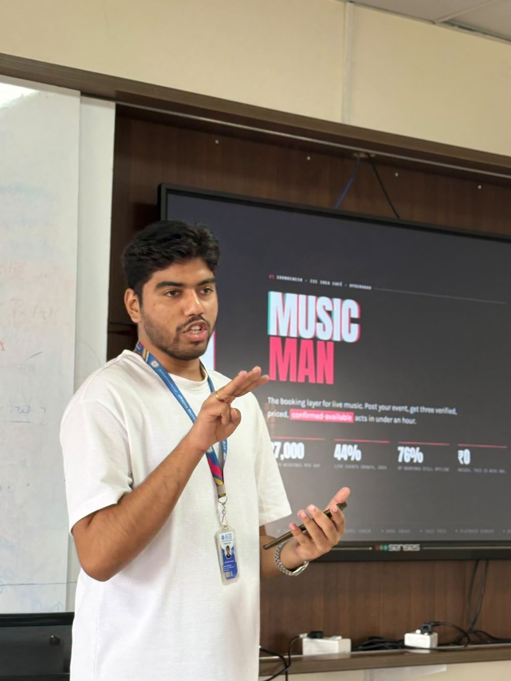 Victor gesturing while presenting the Music Man slide with market figures