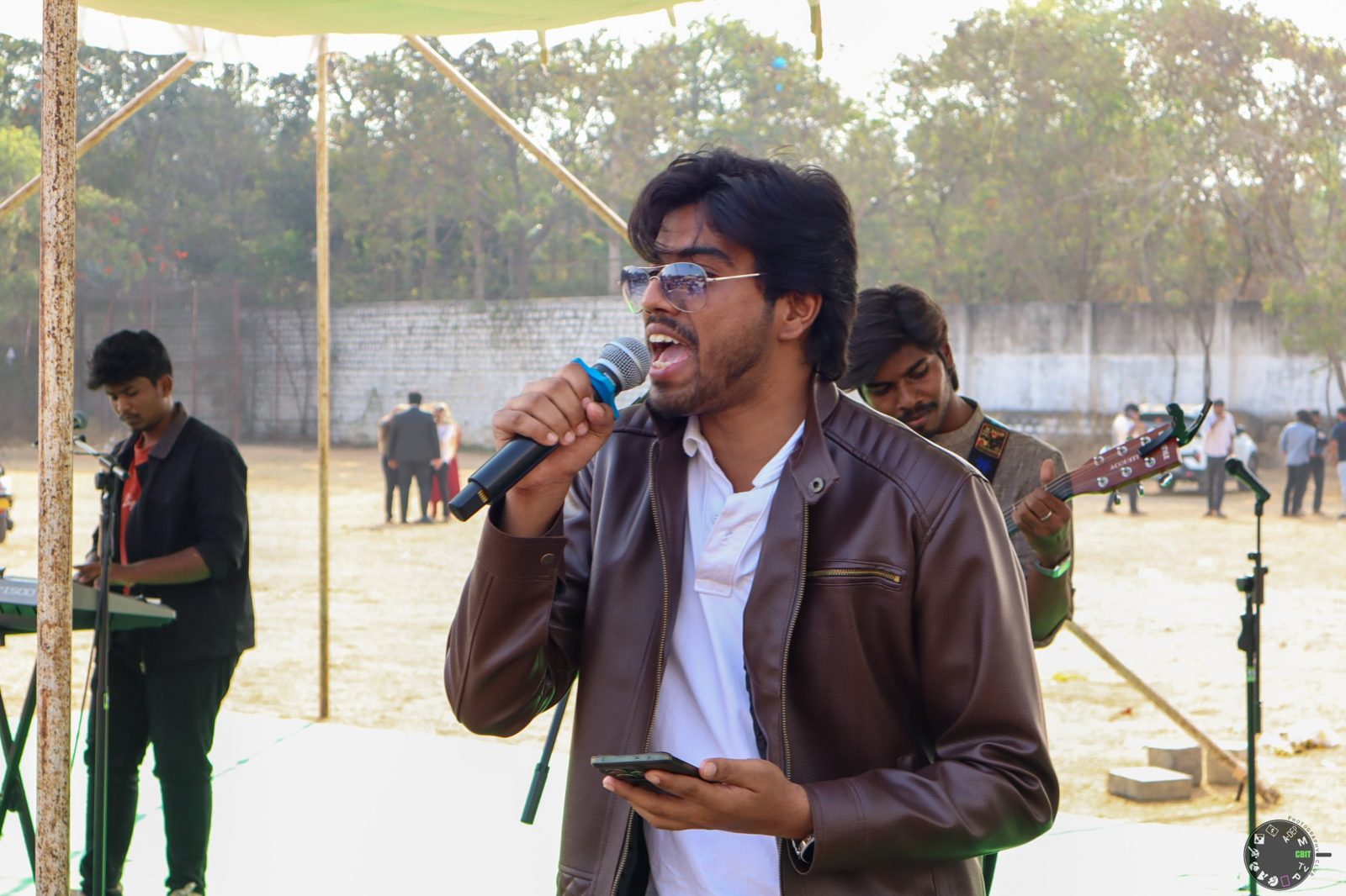 Victor singing on the CBIT stage in a leather jacket